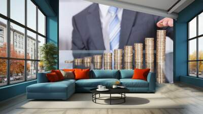 businessperson with stack of coins Wall mural