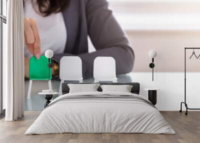 businesswoman choosing green chair among white chairs in a row Wall mural