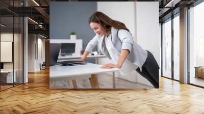 Businesswoman Doing Push Up On Office Desk Wall mural