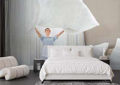 Female Housekeeping Worker Making Bed Wall mural