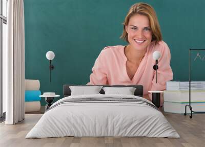 Female Teacher Studying At Desk Wall mural