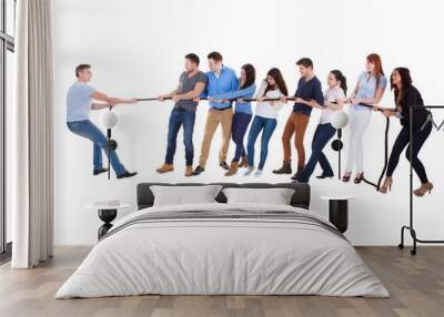 Group of people having a tug of war Wall mural