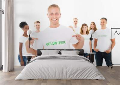 Happy Man Showing Volunteer Text On Tshirt Wall mural