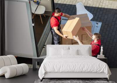 Male Movers Unloading The Cardboard Boxes Form Truck Wall mural