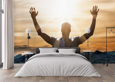 Man Raising His Arm At Sunset Wall mural