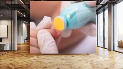 Mother Cutting Her Baby Finger Nail Wall mural