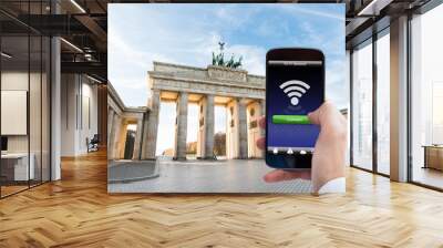 Person Hand With Mobile Phone At Brandenburg Gate Wall mural