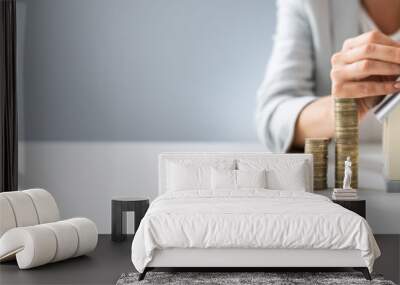 Person Inserting Coin In The House Model Wall mural