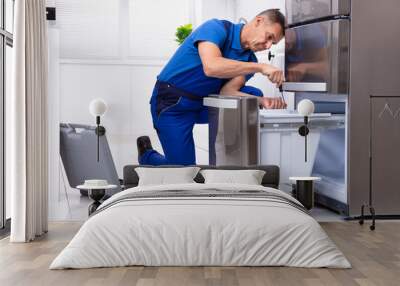 Serviceman Repairing Refrigerator Wall mural