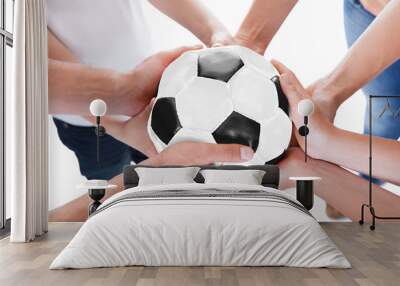 Several Hands Holding Together Soccer Ball Wall mural