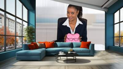 Smiling Businesswoman Holding Piggybank Wall mural