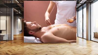 Therapist Applying Wax On Man's Chest Wall mural