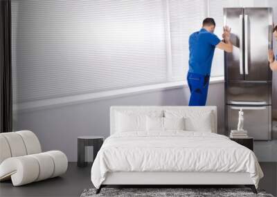 Two Movers Placing Refrigerator In Kitchen Wall mural