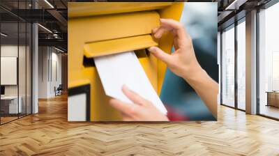 woman's hands inserting letter in mailbox Wall mural