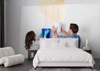 Woman And Repairman Collecting Water From Ceiling Wall mural