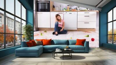 Woman Sitting On Messy Kitchen Floor Wall mural