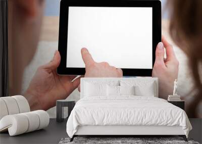 Young couple looking at a tablet together Wall mural