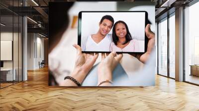 Young Couple Using Digital Tablet Together Wall mural