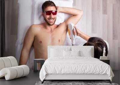 Young Man Having Underarm Laser Hair Removal Treatment Wall mural