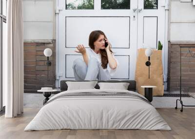 Young Woman Waiting In Front Of Closed Door Wall mural