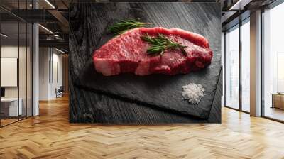 raw fresh strip loin steak on black wooden background Wall mural