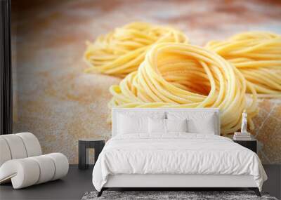 raw homemade spaghetti nest with flour on a wooden table. fresh Italian pasta Wall mural