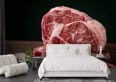 Raw rib eye beef steak with pepper and herbs on a wooden background in a butcher shop Wall mural