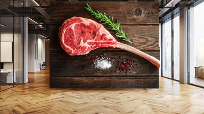 raw Tomahawk steak on wooden background with spices for grilling Wall mural