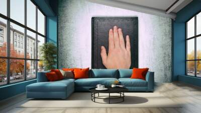 A male palm on a book, an oath on the bible, Top view close up Wall mural