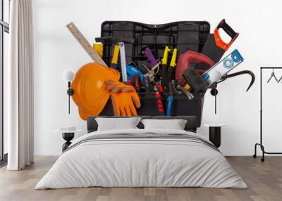 an open black plastic tool kit box with an orange construction protective helmet and various hand tools isolated on a white background close up Wall mural