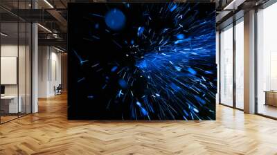 bright blue sparks on black background Wall mural