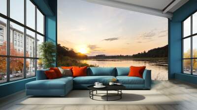 Sunset by the river in the summer countryside Wall mural