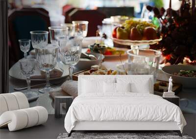 table setting for a festive dinner. empty wine glasses, tableware and snacks. Wall mural