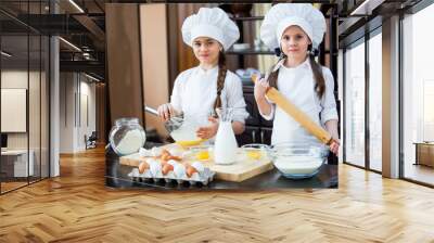 two girls make flour dough. Wall mural