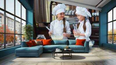 two girls make flour dough. Wall mural