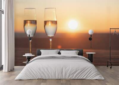 two glasses of champagne on the table at sunset Wall mural