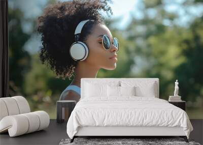 young attractive fashionable young girl or woman in headphones enjoying music holding glass of coffee drink outdoor Wall mural