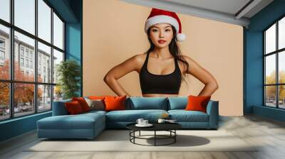 young pretty woman in santa hat and sport wear, christmas sportive lifestyle Wall mural