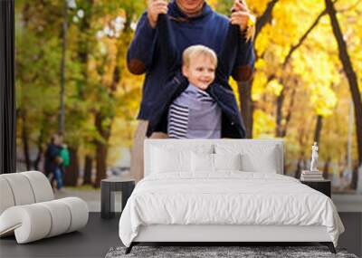 Blonde little boy in autumn park Wall mural