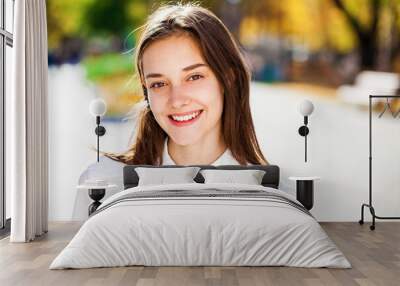 Close up portrait of a young brunette girl in white shirt Wall mural