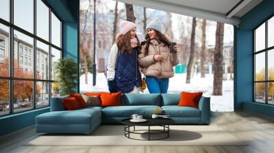 Close up portrait of two young girls walking in a winter park Wall mural