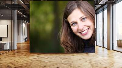 Closeup portrait of a happy young woman smiling Wall mural