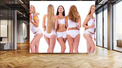 Fitness women. Three young beautiful girlfriends in white sportswear Wall mural