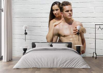 Muscular young man and sexy naked woman Wall mural