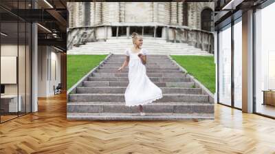 Portrait of a beautiful young little girl in white gown Wall mural