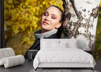 Portrait of a young beautiful model in a black leather jacket Wall mural