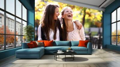 Two cheerful girls twins, in the street Wall mural