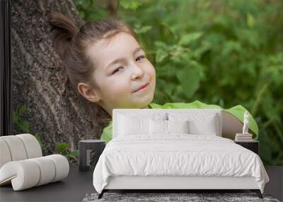 young beautiful preschool girl in a summer park Wall mural