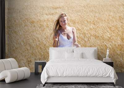 Young beautiful woman in a long white dress is sitting in a whea Wall mural