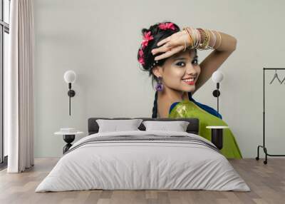 Young pretty woman in indian green dress Wall mural